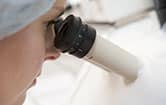 scientist using microscope