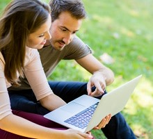 Man and woman looking at laptop