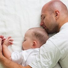dad sleeping with baby