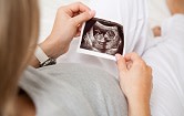 pregnant woman hugging belly with husband