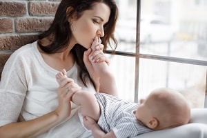 woman kissing baby