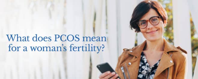 woman smiling holding phone -PCOS Blog-feature